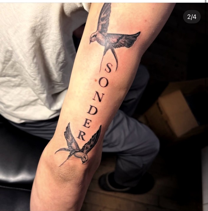 Sonder lettering and bird tattoo by Owen Webb